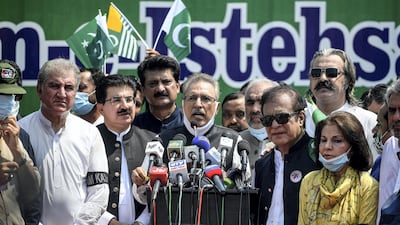 President Arif Alvi (C) spoke out against his French counterpart Emmanuel Macron's anti-separatism bill. AFP