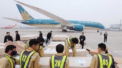 Officials move coffins containing the bodies the victims found dead in a refrigerated lorry in Britain, at the Noi Bai International Airport in Hanoi, Vietnam. EPA