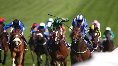 Jockey Paul Hanagan, blue and white, rides Taghrooda to a win in the English Oaks. Charlie Crowhurst / Getty Images