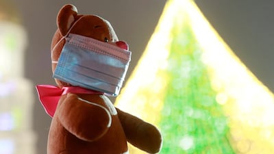 A toy bear with a protective mask is seen at a Christmas fair in central Kyiv, Ukraine. Reuters