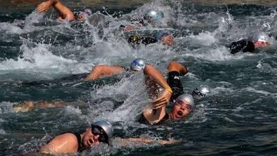 Athletes hit the water in the inaugural Tri Yas triathlon at Yas Island yesterday. Jasper Blake, 37, won as he needed just under two hours to swim 1,500 metres, cycle 40 kilometres and run 10km.