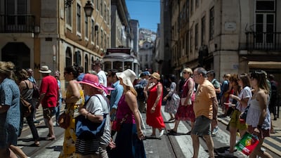 People walk down Rua Augusta street in downtown Lisbon. Portuguese's total public revenue grew by 11 per cent to more than €102 billion in 2022. AFP