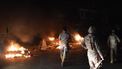 Pakistani Rangers walk past burning motorbikes on a street in Karachi after they were set alight by protestors after the arrest of hardline cleric Khadim Hussain Rizvi. Pakistani police detained a hardline cleric whose party recently paralysed the country with violent protests over the acquittal of a Christian woman accused of blasphemy. AFP