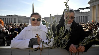 Nuns with olive branches wait before a mass for Palm Sunday by Pope Leo XIV at St Peter's square in the Vatican. AFP