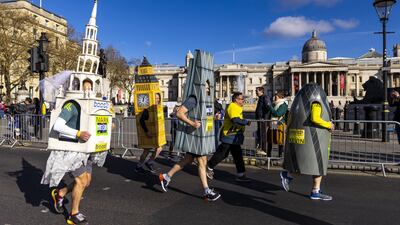 Runners dressed up as famous London buildings head past the National Gallery during the London Landmarks Half Marathon. PA