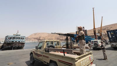 A Yemeni government soldier mans a machine gun mounted on a pickup truck at the docks in Mukalla. AFP