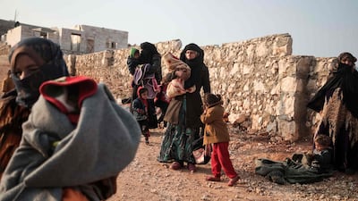Displaced Syrians from the south of Idlib province queue to receive food aid from a truck in the countryside west of the town of Dana in the northwestern Syrian region. AFP