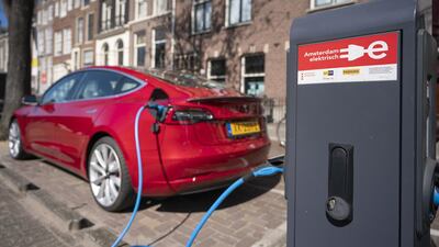 A Tesla Model 3 electric car recharges in Amsterdam, Netherlands. Bloomberg