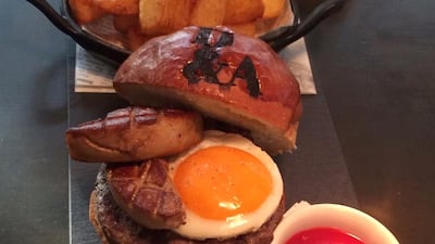Try the bone marrow burger topped with seared foie gras and a fried organic hen’s egg at D&A. Courtesy Dhow & Anchor