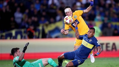 Goalkeeper Jeremias Ledesma and Alfonso Parot of Rosario Central in action against Sebastian Villa of Boca Juniors during the Argentine Supercopa final. EPA