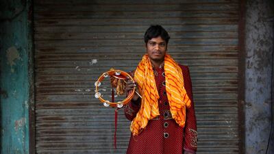 Salim, 23, from Agra, a member of Master Band specializing in playing weddings, poses for a portrait in New Delhi.