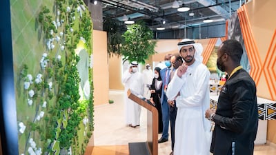 Sheikh Shakhbout discusses a pavilion exhibit.
