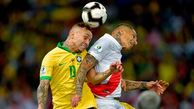 Peru's Paolo Guerrero and Brazil's Everton enjoy an aerial duel. AFP