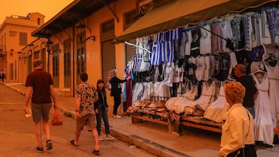 Taking a stroll in the Greek capital during the dust storm. EPA