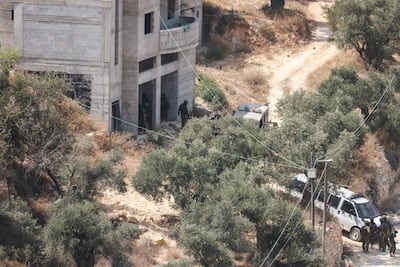 Israeli soldiers at the scene where settlers attacked a Paletinian home in the village of Qusra. AFP