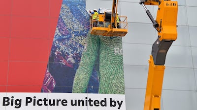 Workers remove a poster featuring Barcelona's departing Argentinian forward Lionel Messi from Camp Nou.