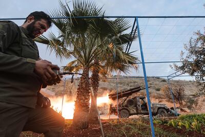 An anti-government fighter remotely fires rockets on regime forces, in the northern outskirts of Hama. AFP