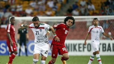Iran’s Ashkan Dejagah, left, fights for the ball with Omar Abdulrahman. Edgar Su/Reuters