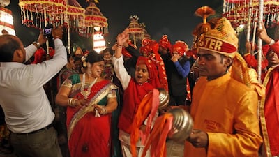 Members of Indian Brass band, play as they accompany a wedding procession, in New Delhi.