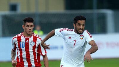 Paraguay's Tonny Sanabria, left, gives chase to the UAE's Ali Mabkhout during their friendly at Villach, Austria, on September 7, 2014. DANIEL RAUNIG / AFP