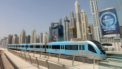 A Dubai Metro train against a backdrop of Dubai skyscrapers. Chris Whiteoak / The National
