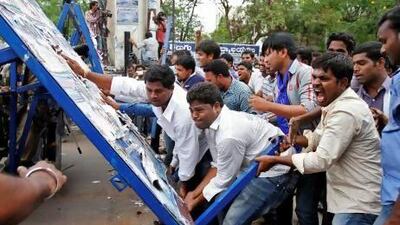 Pro-Telangana supporters overturn a barricade during a protest rally in the southern Indian city of Hyderabad.