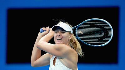 Maria Sharapova returns a shot against Kaia Kanepi during her first round victory at the China Open on Sunday in Beijing. Feng Li / Getty Images / September 28, 2014