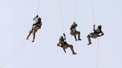 UAE Presidential Guard female members repel from a helicopter during a live demonstration at Idex 2015. Silvia Razgova / The National