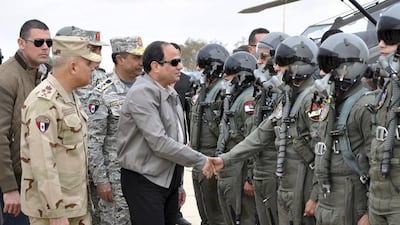 Handout of Egyptian president Abdel Fattah El Sisi greets pilots and crews of the Egyptian Air Force near the border between Egypt and Libya on February 18, 2015. Mr El Sisi was touring the border area with Libya on Wednesday, two days after Cairo bombed ISIL targets there. Egyptian Defence Ministry/Handout via Reuters