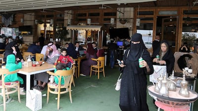 Men and women eat food in a restuarant in Riyadh. Reuters