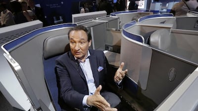 United Airlines CEO Oscar Munoz speaks during an interview in New York, while seated in the seating configuration of the carrier's new Polaris service. United Airlines says it will raise the limit to $10,000 on payments to customers who give up seats on oversold flights. Richard Drew / AP Photo