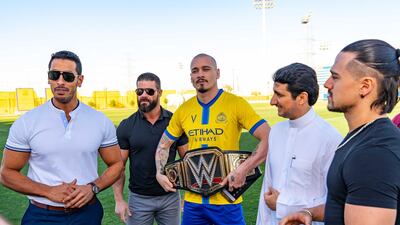 A member of Al Nassr football club gets presented with the WWE Championship in Riyadh. Photo by Craig Melvin