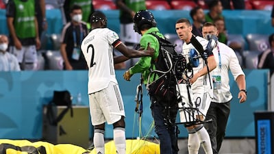 The protester is helped up by German footballer Antonio Rudiger. Getty Images