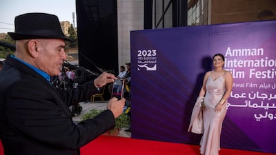 This handout picture released by the Amman International Film Festival (AIFF) shows Palestinian film director Rashid Masharawi taking a photo of Tunisian critic Henda Haouala as they attend the 4th edition of the AIFF in Jordan's capital on August 15, 2023. (Photo by Ammar ABD RABBO / Amman International Film Festival (AIFF) / AFP) / RESTRICTED TO EDITORIAL USE - MANDATORY CREDIT "AFP PHOTO / AIFF NO MARKETING NO ADVERTISING CAMPAIGNS - DISTRIBUTED AS A SERVICE TO CLIENTS -
