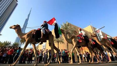Dubai residents participate in the Parade to mark the UAE's 41st National Day in Downtown Dubai. Satish Kumar / The National