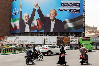 A billboard of Iranian President Masoud Pezeshkian (R) and late Hamas leader Ismail Haniyeh at the Valise square in Tehran, on August 1. AFP