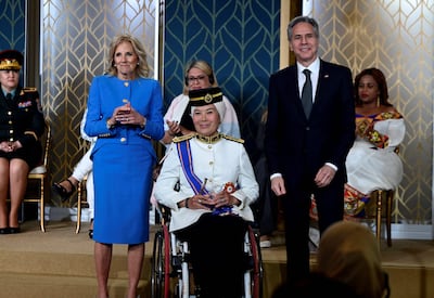 US first lady Jill Biden and US Secretary of State Antony Blinken pose with Malaysian Senator Datuk Ras Adiba Radzi, who spoke on behalf of the afternoon's honourees. AFP