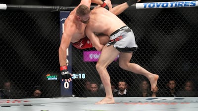 Magomed Ankalaev, right, takes down Jan Blachowicz during their title bout at UFC 282. AP