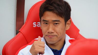 Shinji Kagawa of Manchester United gives a thumbs-up from the bench prior to United's Premier League match against Sunderland on Sunday. Michael Regan / Getty Images / August 24, 2014