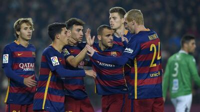 Barcelona player Munir El Haddadi, third left, celebrates with Sergi Samper, left, Aitor Cantalapiedra, second left, Sandro Ramirez, third right, Gerard Gambau, second right and Jeremy Mathieu, right, after scoring one of his two goals in the Copa del Rey on Wednesday. Lluis Gene / AFP