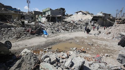 Iraqis inspect the damage in west Mosul’s Al Jadida district on March 26, 2017. Estimates of the number of civilians killed in fighting for the area range from dozens to hundreds. Ahmad Al Rubaye / AFP