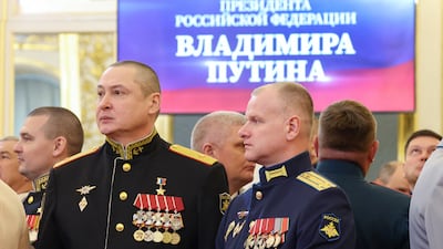 Military officers involved in Russia's campaign in Ukraine wait before the ceremony. Reuters