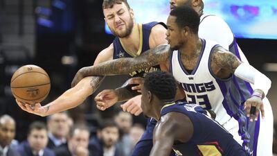 New Orleans Pelicans centre Donatas Motiejunas (12) battles for control of the ball with Sacramento Kings defenders DeMarcus Cousins (15) and Ben McLemore (23) during an NBA basketball game in Sacramento, Calif. The Kings won 105-99. Steve Yeater / Associated Press / February 12, 2017
