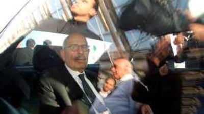 Journalists and security guards surround the vehicle transporting the head of the UN atomic watchdog, Mohamed ElBaradei, upon his arrival at Tehran's Imam Khomeini airport yesterday ahead of talks with Iranian atomic officials on the country's controversial nuclear programme.