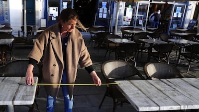 A waiter makes sure tables are correctly distanced in Montpellier. EPA