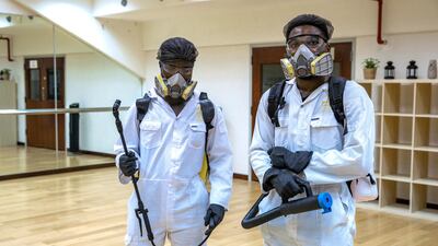 Sanitation workers at Haddins Fitness, Zayed Sports City. Victor Besa / The National