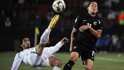 Iraqi defender Mohammed Ali Kareem fights for the ball with New Zealand Leo Bertos during the Fifa Confederations Cup.