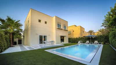 The backyard has been landscaped with a pool, patio and custom lighting. Courtesy LuxuryProperty.com