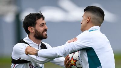 Joao Cancelo and Bernardo Silva have a laugh during training. AFP