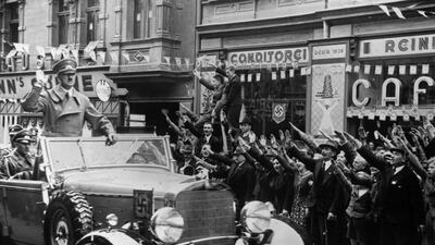 1st October 1938: Adolf Hitler (1889 - 1945) is greeted with the Nazi salute as he heads a convoy through Sudetenland, which had become part of the Third Reich after the Munich Pact. Getty